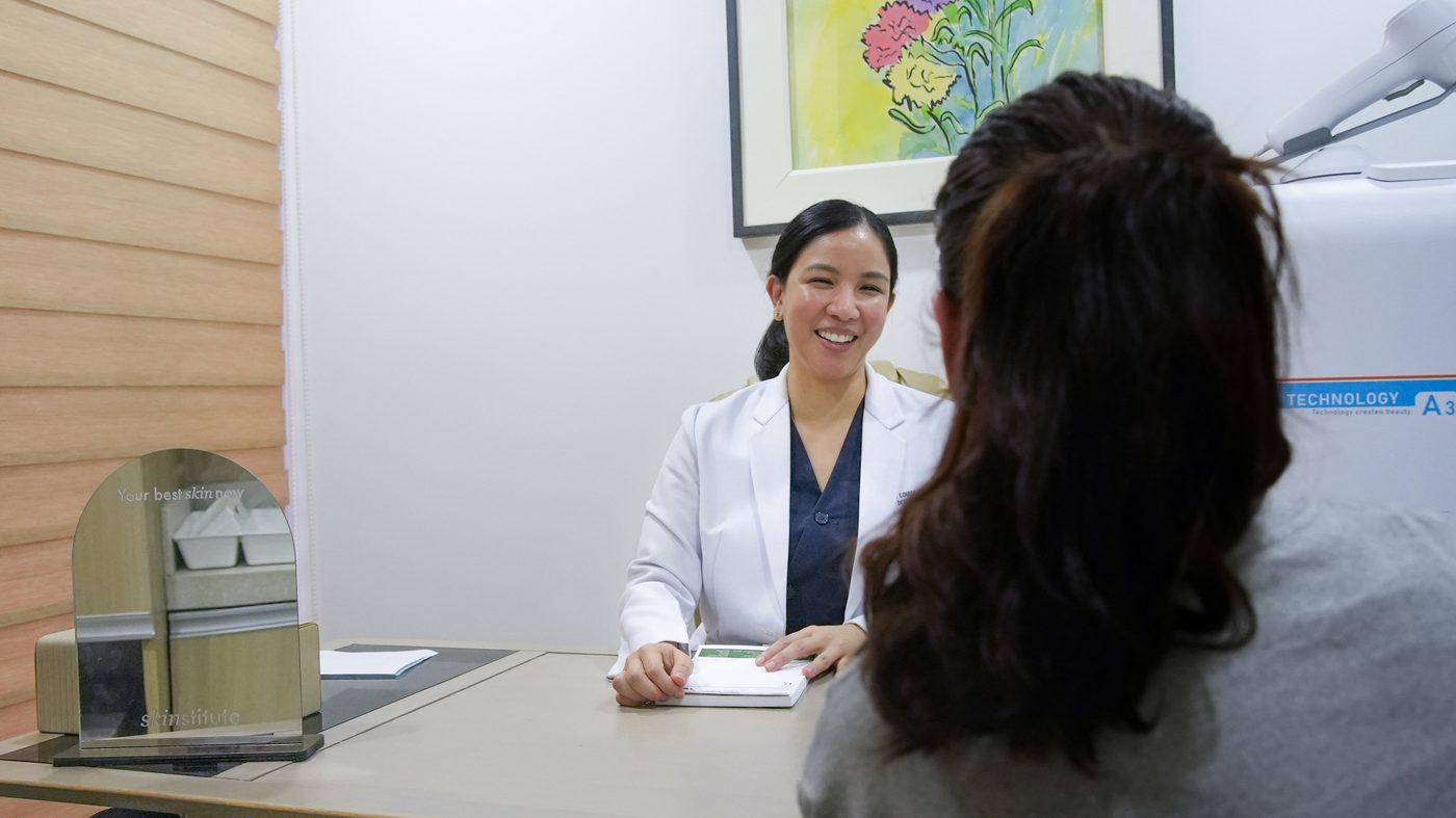 A dermatologist checking a patient's skin at Skinstitute MD in Quezon City